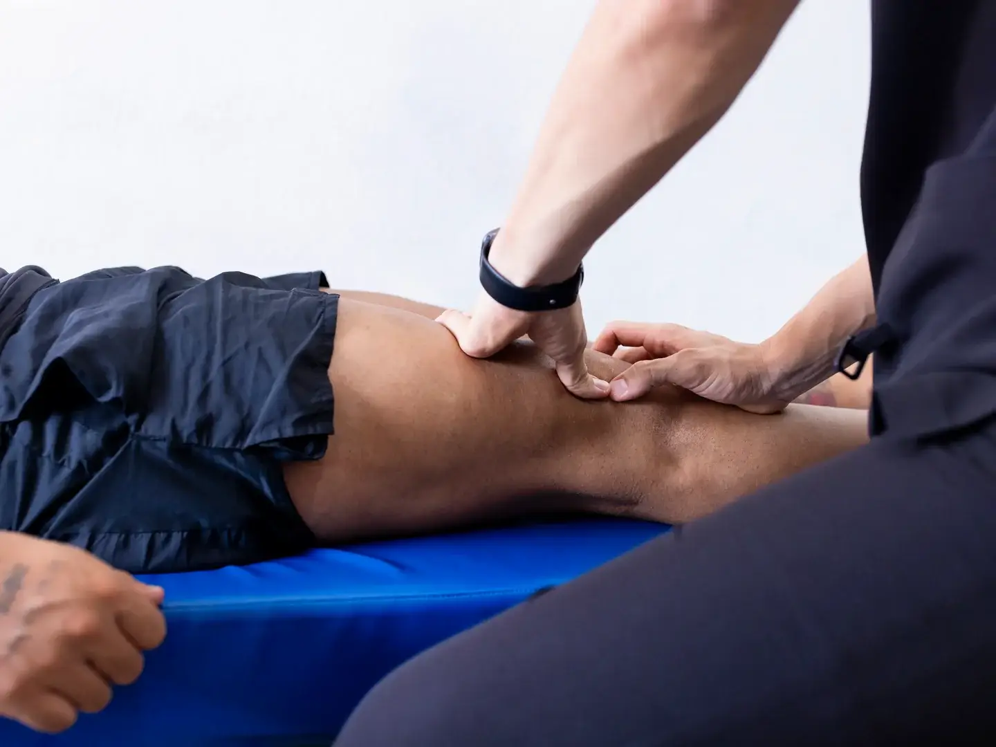 A clinician providing hands-on knee rehabilitation